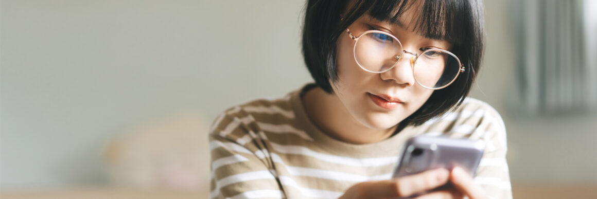 teen girl looking at smart phone