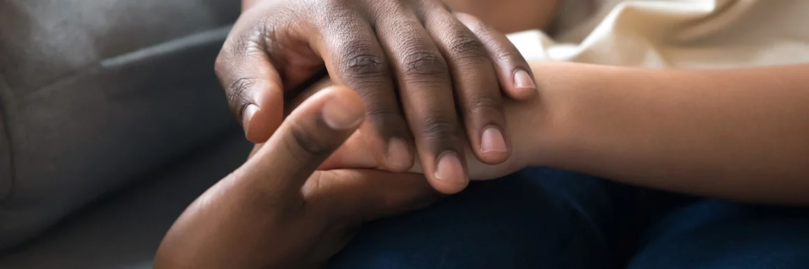 Supportive hands, adult holding teen child's hands