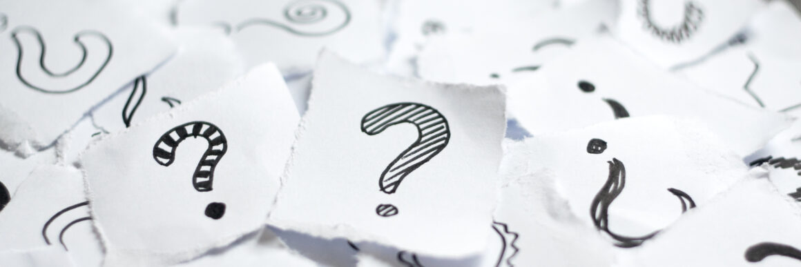 Many question marks on white papers. Doodle drawn question marks on scraps of paper. Choice, decision making, assortment concept