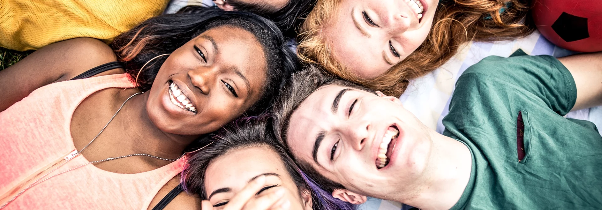 bright, smiling group of diverse teens laughing together