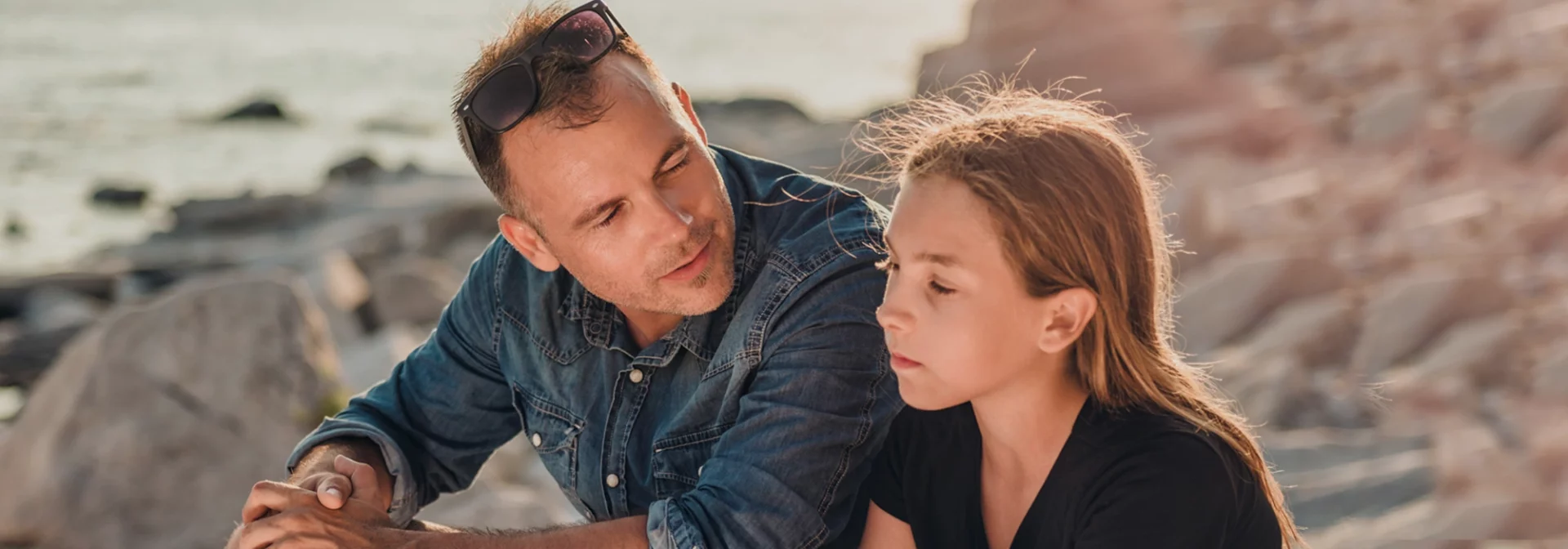 dad and daughter talking outside, offering support, mental health check-in