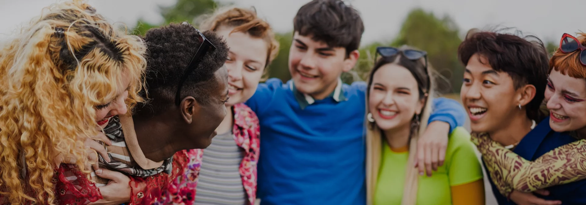 LGBTQ teens hugging and smiling together