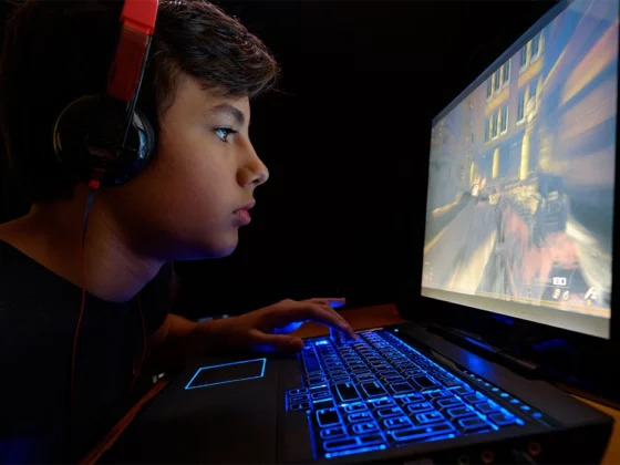 preteen boy on computer screen in room, teen headphones on, screen time for teens