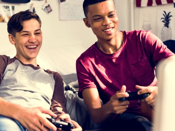 teen boys gaming together in room