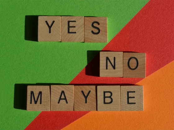 yes no maybe written in scrabble letters on colorful background
