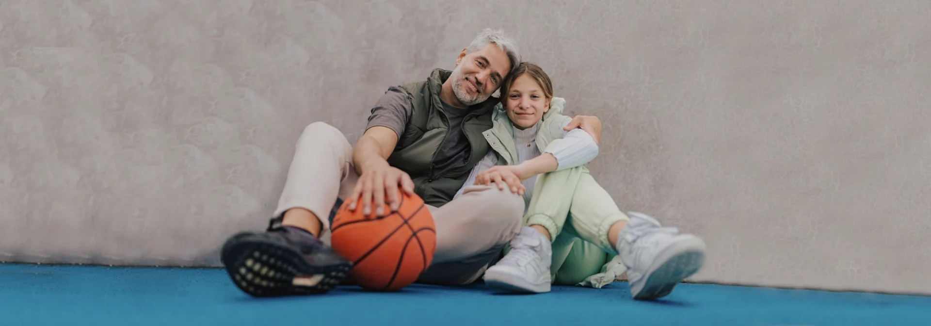 dad and daughter sitting together in hug, loving supportive parent of teen