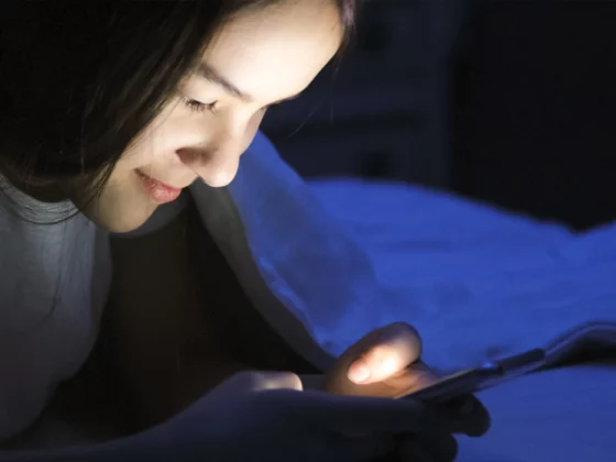 teen on phone in bed, smartphone in bed