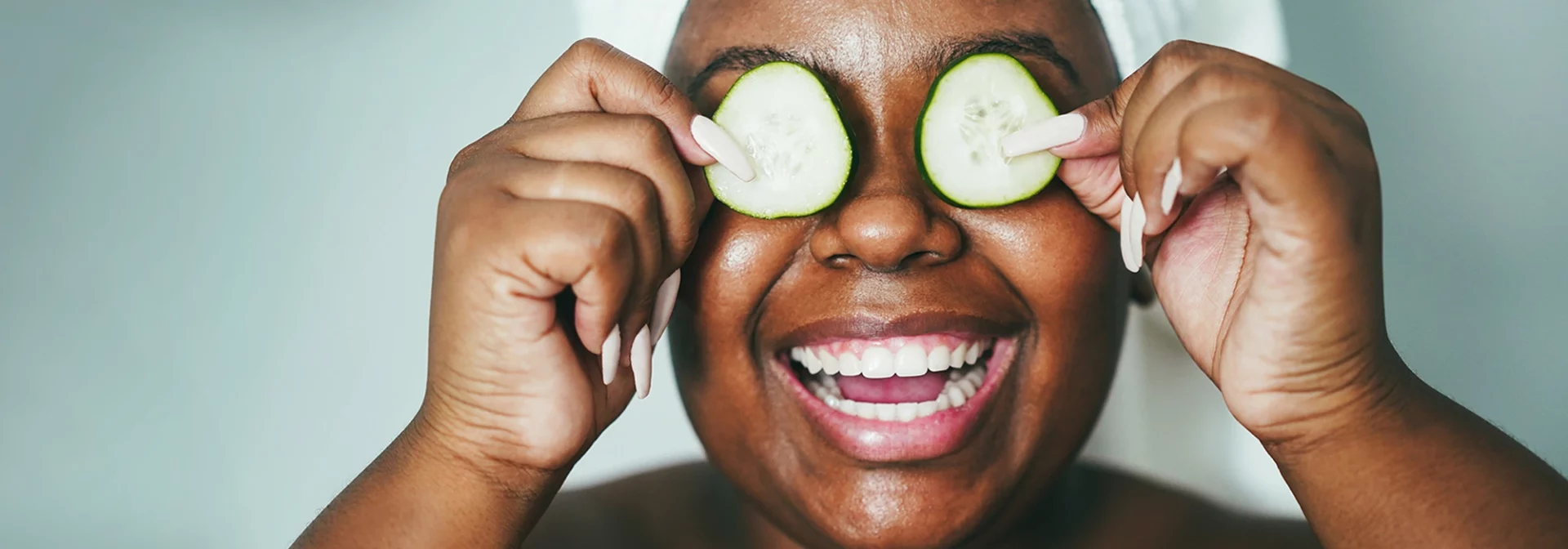 diverse teen with cucumbers on eyes, skin care routine
