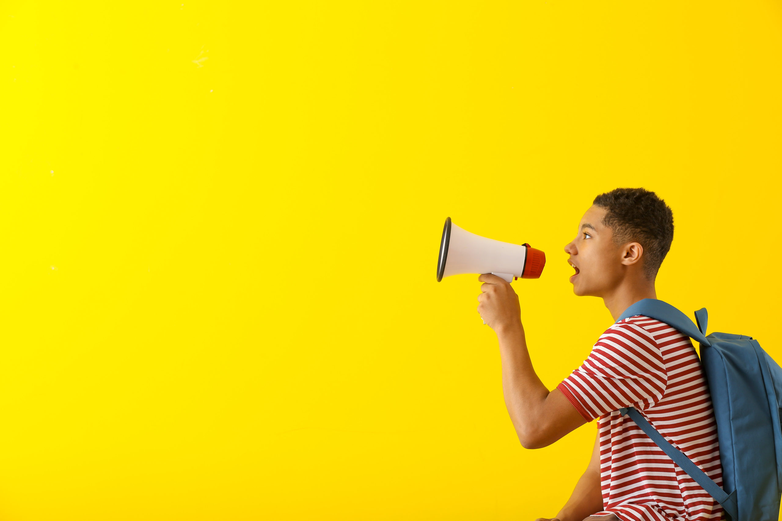 Portrait,Of,African-american,Teenage,Boy,With,Megaphone,On,Color,Background