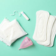 Menstruation period concept on mint background, top view