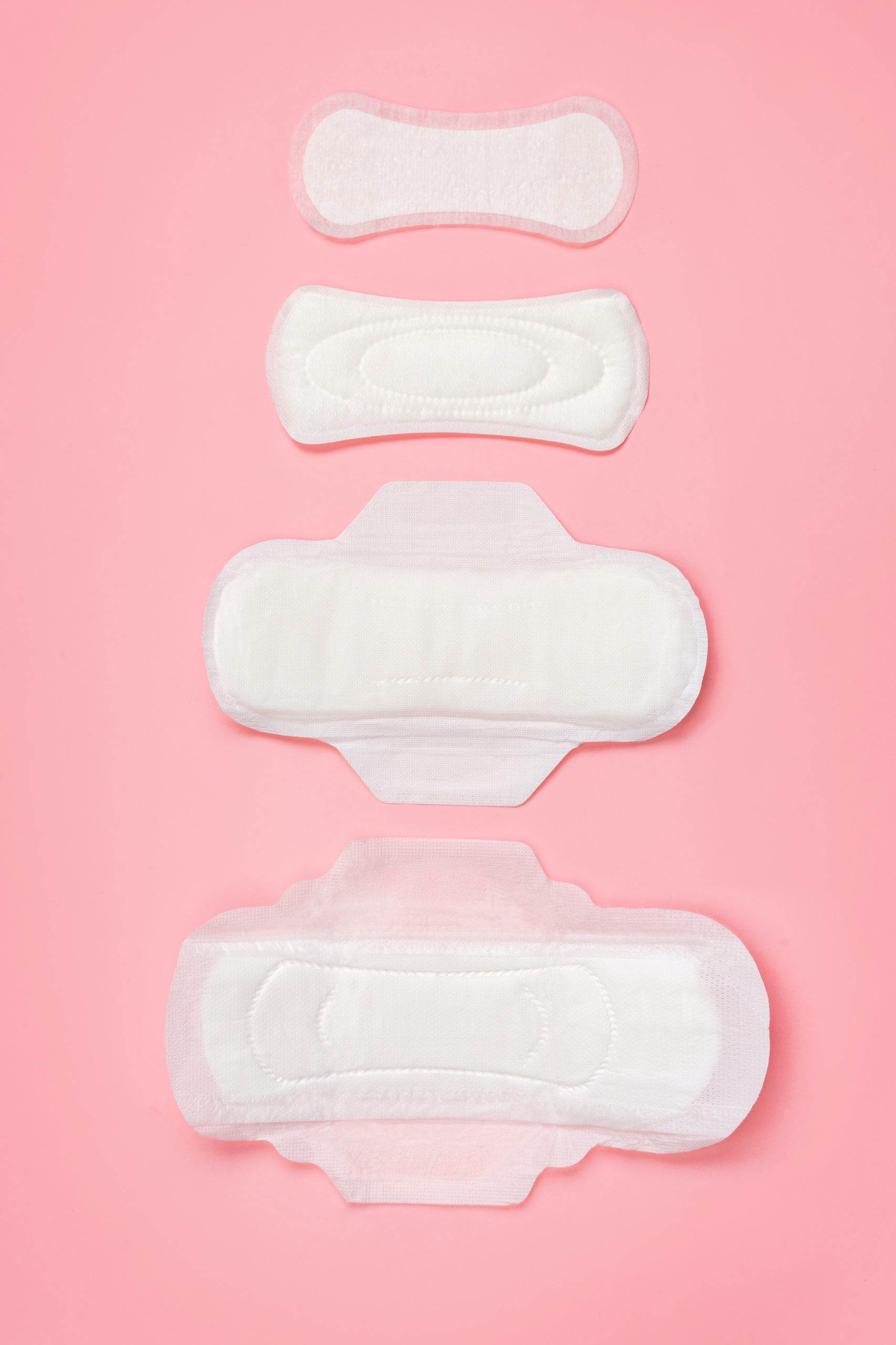 Set of different sanitary napkins on pink background. Concept of critical days, menstruation