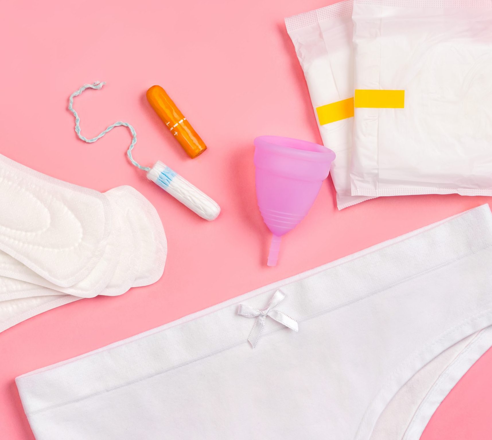 White,Pants,With,Sanitary,Napkins,,Tampons,,Menstrual,Cup,On,Pink
