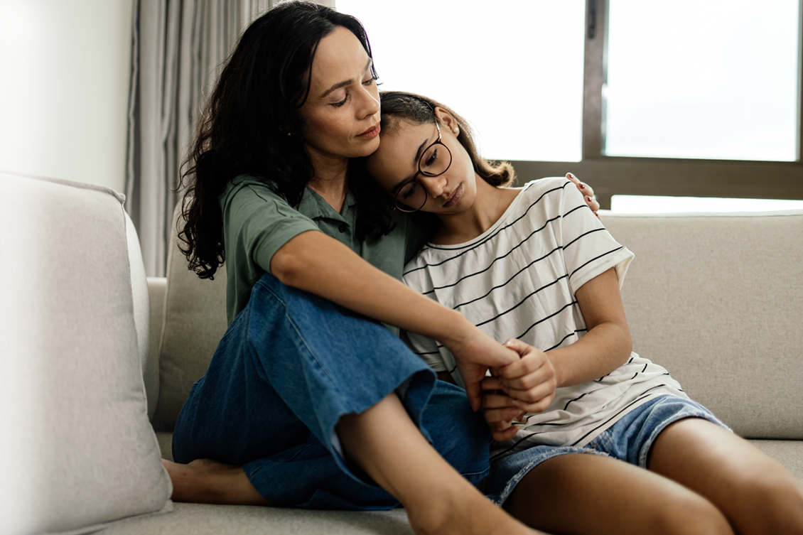 mom and daughter hugging. Teen depression with supportive mother, caregiver.